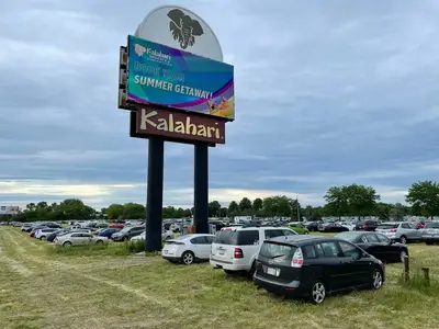 Cars park in the open fields during a busy Colossalcon weekend.