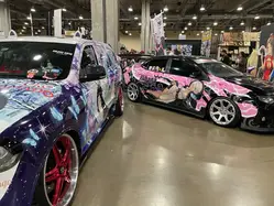 Itasha cars in the vendor hall.