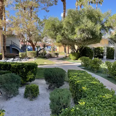 Walkways wrap around landscaping and trees.