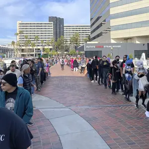 Attendees queue to enter the building.