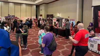Creators line the walls of the vendor hall.