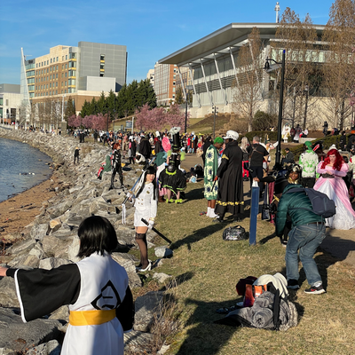 Cosplayers and photographers line the waterfront.