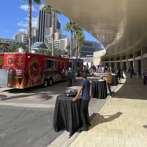Food trucks line the convention center entrance.