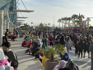 Attendees fill the boardwalk and wait in line at the food trucks.