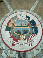 <a href="https://en.wikipedia.org/wiki/Seal_of_Texas" target="_blank">The Seal of Texas</a> sits in the center of the atrium floor.